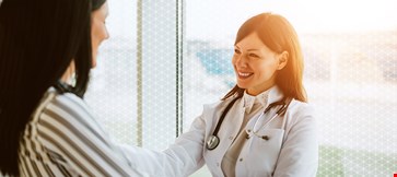 Doctor is discussing with patient with smile