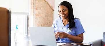 Happy woman working on laptop