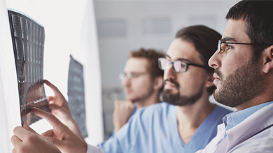 Healthcare, medical: Group of multi-ethnic doctors discuss and looking x-ray in a clinic or hospital