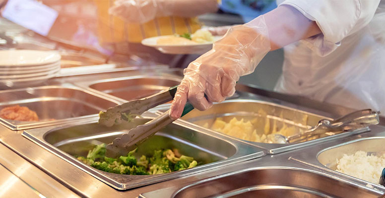 Chef standing behind full lunch service station