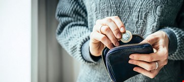 hands-holding-one-euro-coin-small