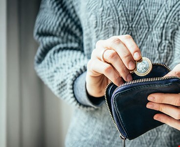 hands-holding-one-euro-coin-small