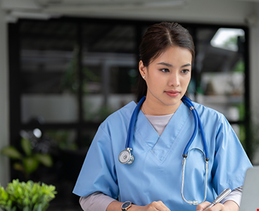 professional-focused-asian-female-doctor-scrubs