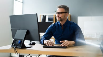 Businessman Using Business Computer In Office Or Workplace