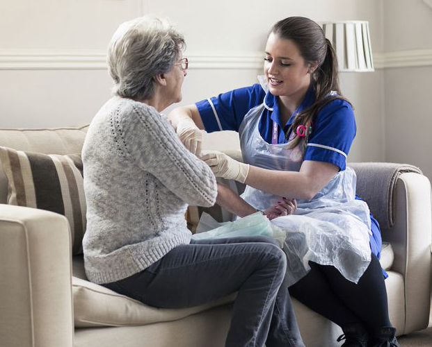 Lady health worker helps elder lady patient