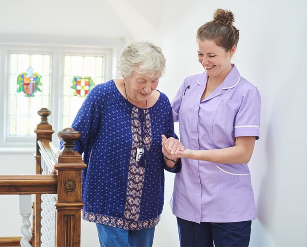 Medical person taking care of elder lady