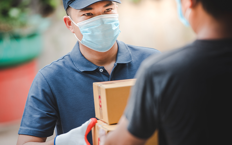 Delivery staff carrying paper boxes wear