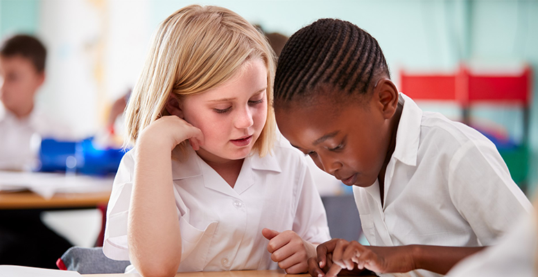 Kids playing on tab in classroom