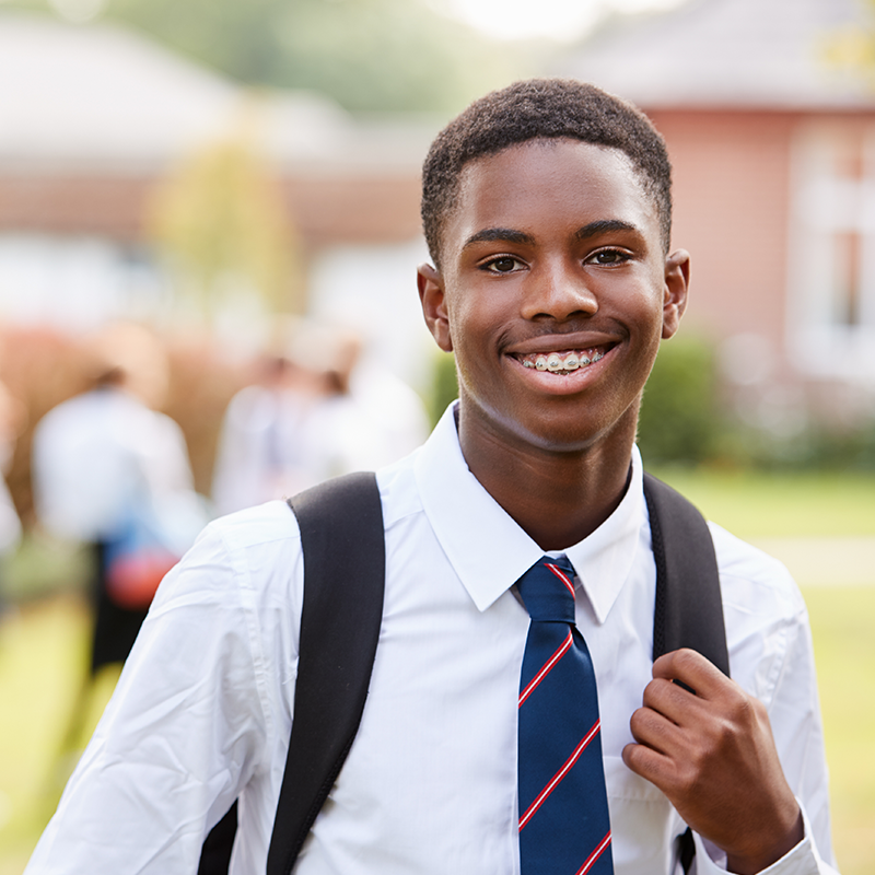 Portrait Of Male Teenage Student In Uniform Outside