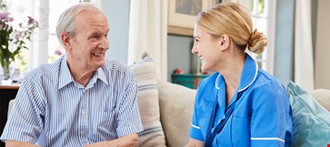 Female Community Nurse Visits Senior Man At Home