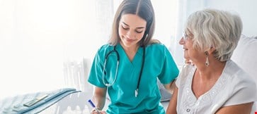 Nurse measuring blood pressure of a senior citizen lady