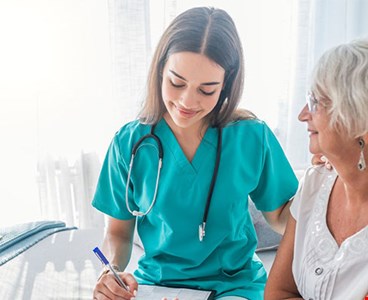 Nurse measuring blood pressure of a senior citizen lady