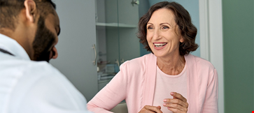 A woman laughing and discussing with a guy