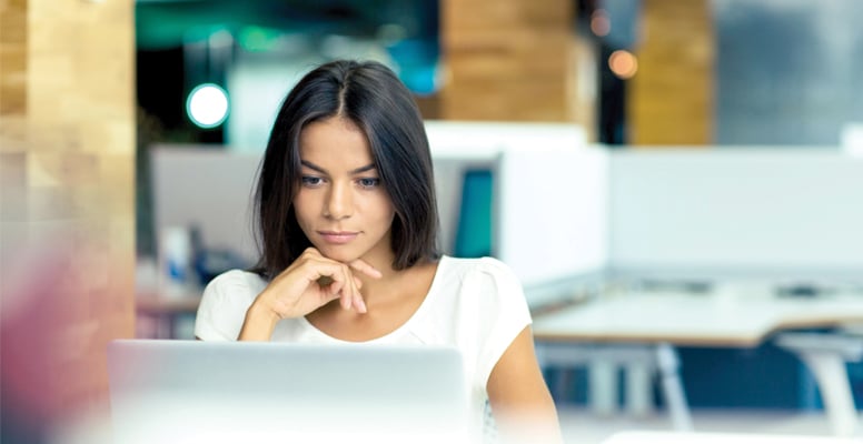 Portrait of a serious business woman working on a laptop