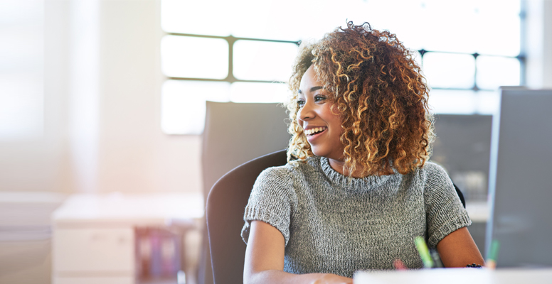 Shot of a smiling young businesswoman using a computer in an office