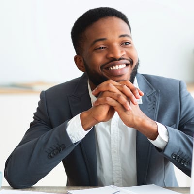 Pensive african american businessman dreaming about something