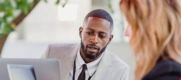 A man looking into the laptop