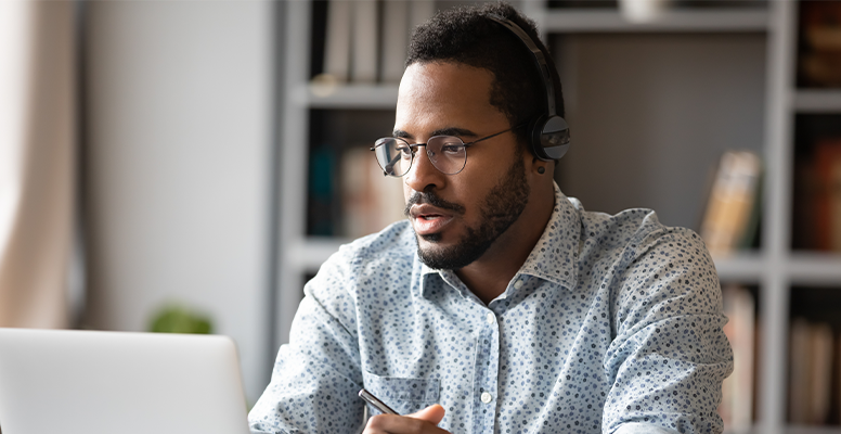 Focused young african businessman wear headphones